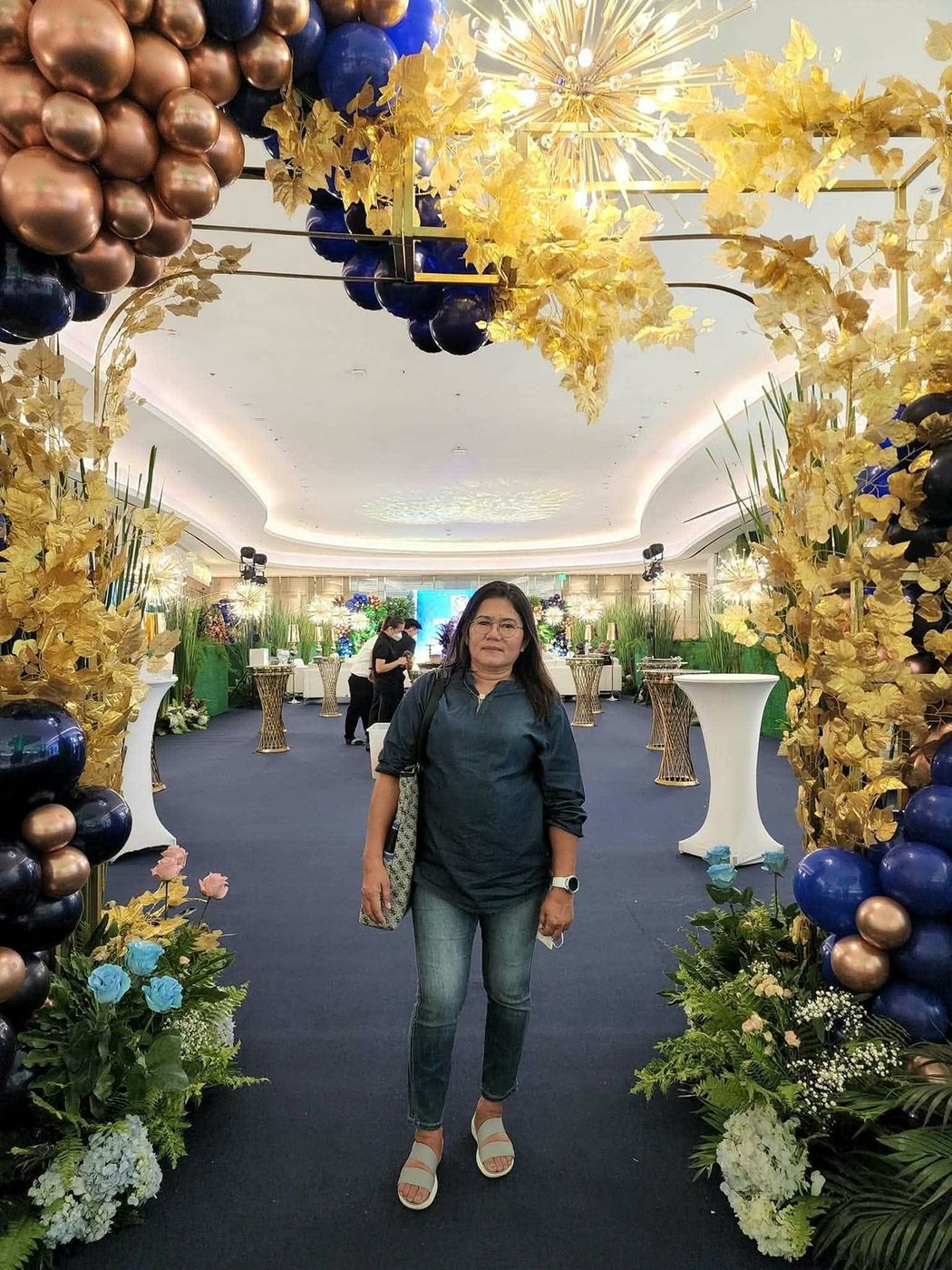 Dydina at an elegant event hall decorated in gold and blue